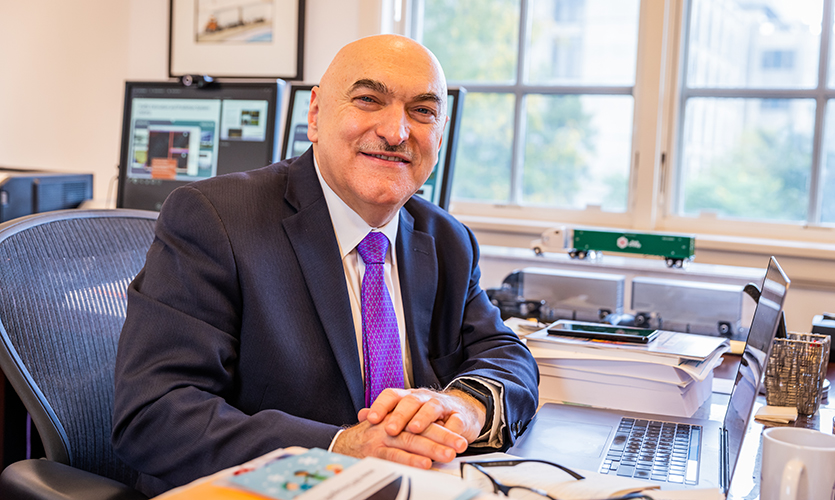 Hani Mahmassani poses for a photo at his desk inside the Northwestern University Transportation Center. Not only a sought-out expert in the transportation field, Mahmassani advised more than 75 doctoral students.