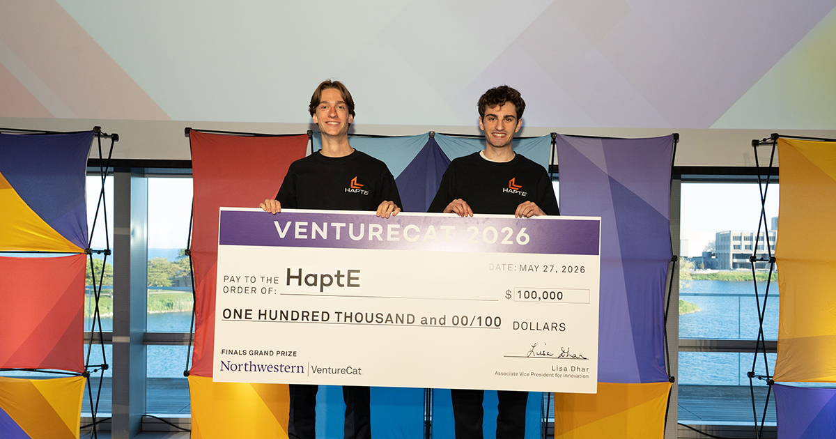 Quinn McGinley, left, and Trevor Abbott pose with their $100,000 check.