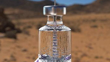 Clear vial in front of landscape