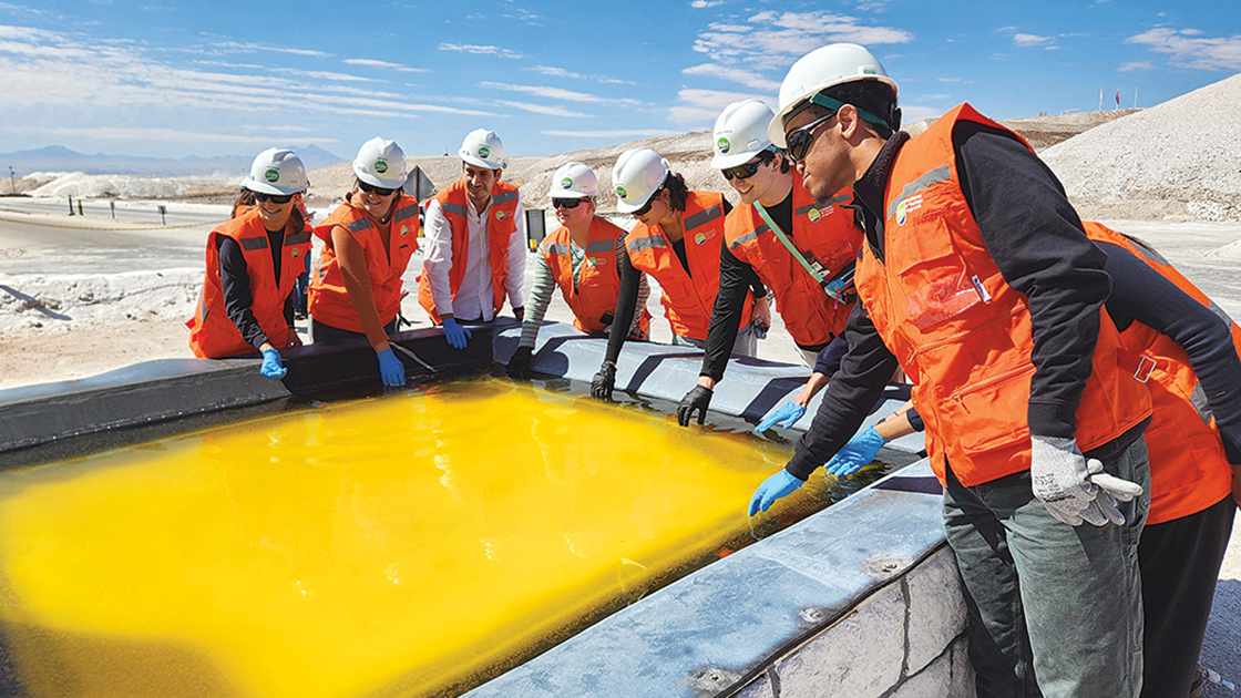 Dunn and Richards have separately traveled with undergraduates through Northwestern’s Global Engineering Trek program to visit lithium and copper mining facilities to learn about how companies are pursuing strategies and technologies to limit water and energy consumption in mining. Here, students observe a lithium brine in an evaporation pool at a lithium extraction facility in Chile. | Photo courtesy of Jennifer Dunn