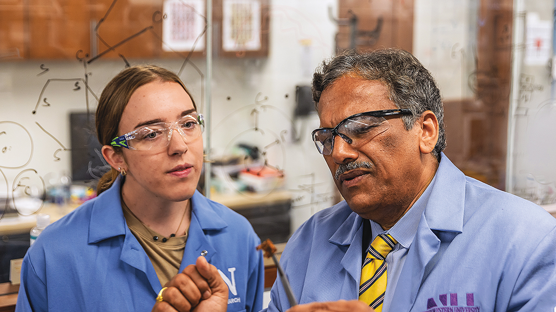 Professor Vinayak Dravid and his student examine a sample of their new nanoparticle-coated sponge in the lab. | Photo by Matthew Allen