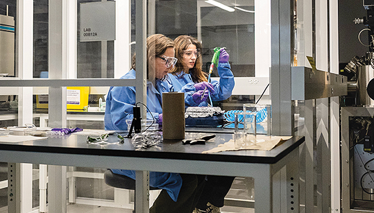IPhD student Aliya Kaplan works with Professor Fowlie in the clean room.
